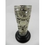 A Chinese white metal flower vase, having pierced designs of flowers and dragons chasing pearls,