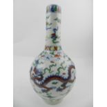 A Chinese Doucai baluster vase, decorated with dragons chasing pearls and foliage, bears six