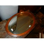 An Edwardian satin wood oval wall mirror. W.75cm