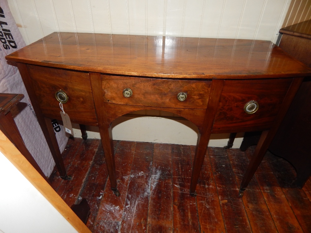 A George III mahogany bow fronted side board, satin wood cross banded, fitted a central drawer