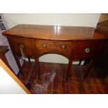 A George III mahogany bow fronted side board, satin wood cross banded, fitted a central drawer