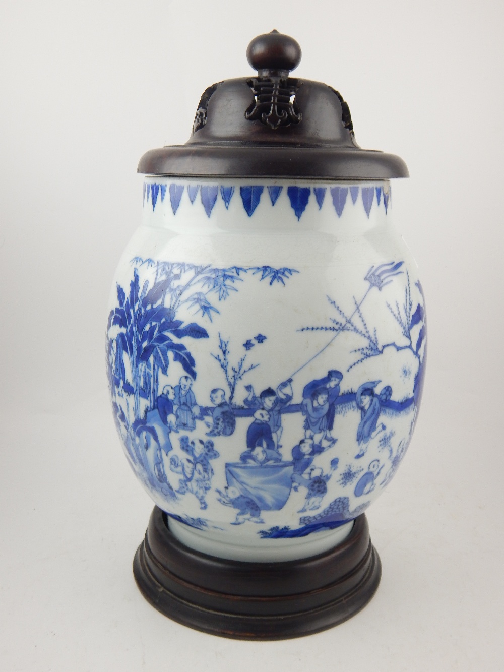 A Chinese porcelain ovoid vase, decorated with children playing in a stylised garden. H.24cm