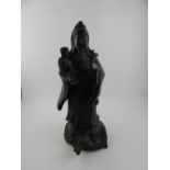 A Chinese patinated bronze figural study of a Buddhist Atva with child and rui, raised on a dragon