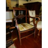 An Edwardian Sheraton Revival mahogany elbow chair.