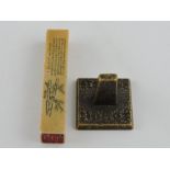 A hardstone rectangular seal, carved to one side with characters and bamboo, H.