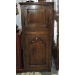 An 18th Century design narrow oak two door cabinet with slide.