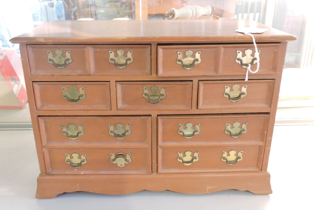 A jewelllery box in the form of a chest of drawers, w. 38cm.