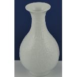 A baluster shaped vase with flared lip, the exterior with moulded decoration of cranes,