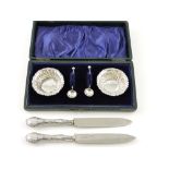 A pair of silver salts, Birmingham 1901, of gadrooned form with a foliate border with two spoons,