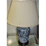 A pair of Chinese style blue and white porcelain tablelamps and shades, H. 32cm.