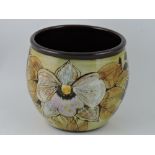 A late 20th century Chelsea Pottery vase, decorated with clematis and signed with initials, H. 16cm.