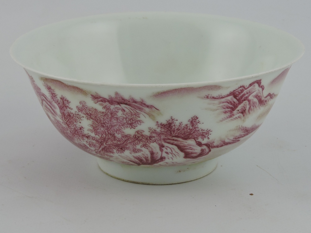 A puce decorated bowl, the exterior with a mountainous landscape, six character mark to base, D.