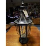 A vintage style octagonal glazed lantern with tea light interior.