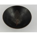 A Jizhou kiln style tea bowl, the black glazed body with impressed leaf design to the interior, D.