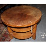 An Art Deco style circular faded walnut three tier occasional table.