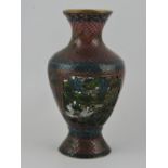 An enamel baluster shaped vase, with pierced panels depicting a bird in foliage, H. 15cm.