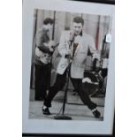 A framed monochrome photograph of Elvis Presley.