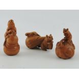 Three carved hardwood netsuke, each formed as a mouse with food, largest H. 6.5cm.
