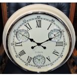 A vintage style circular cream metal wall clock marked Roman numerals with three subsidiary dials.