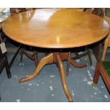 A Victorian style circular oak extending dining table on turned pillar and quadruple cabriole base,