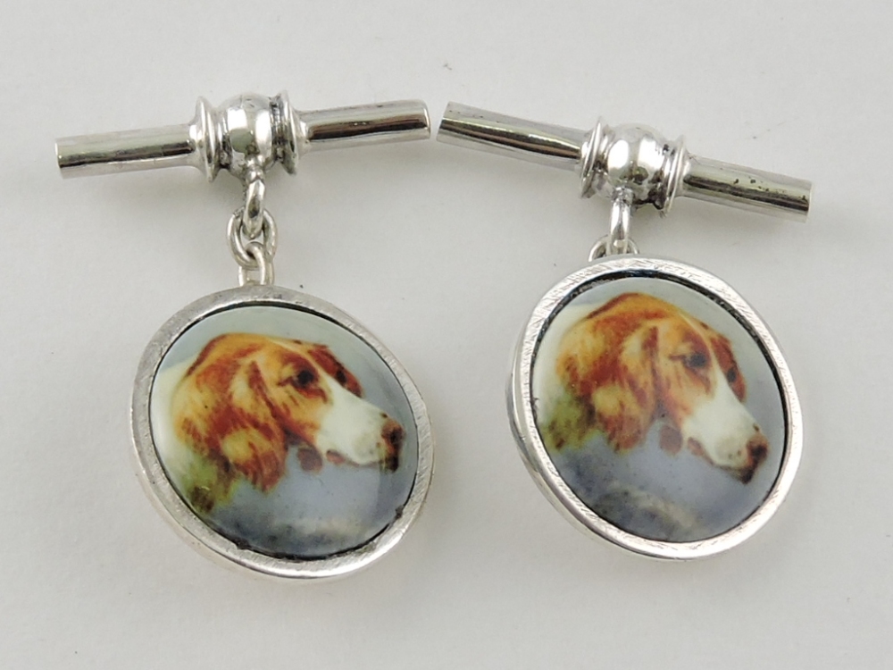 A pair of white metal cufflinks, the discs with hunting dog's heads, on chain and bar, 10g.