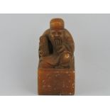 A carved hardstone square seal, topped with seated wiseman, H. 7.5cm.
