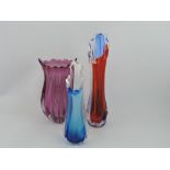 Three 20th century glass vases, ribbed bodies with shaped lips, largest H. 28cm.