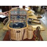 A wicker picnic basket, together with a military brass and copper bugle.