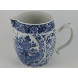 A blue and white jug, decorated with a scene of figures and houses in a mountainous river landscape,