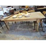 A late Victorian stripped pine kitchen table with rectangular cleated planked top on turned tapered