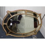 A 19th Century giltwood and gesso cartouche wall mirror with marginal plates