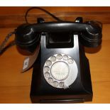 A vintage GPO black Bakelite cradle telephone.
