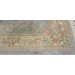 A Chinese pale blue ground carpet with wide floral border approx. 12ft x 8ft.