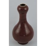 A baluster shaped vase, with bulbous neck and a sang-de-boeuf glaze, H. 17.5cm.