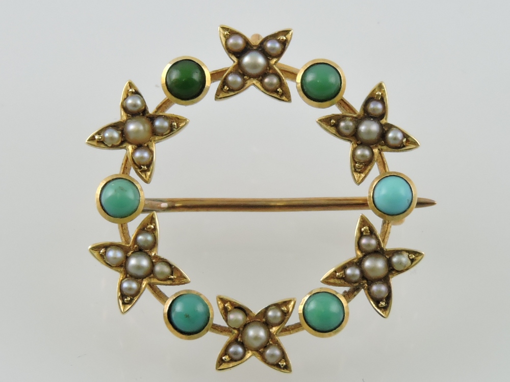 An early 20th century seed pearl and green stone brooch, in the from of a hoop set with flowers, 3.