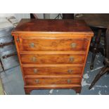 A small Georgian design yew bachelors chest with hinged top over four drawers. 62cm.