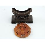 A oriental hardwood table stand, the disk carved in the form of a butterfly, W. 7cm.