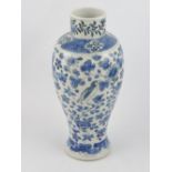 A Chinese late 19th Century blue and white baluster vase decorated with birds amongst flowers and