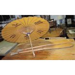 A pair of vintage estuary brand Dinghy oars and a Chinese parasol.