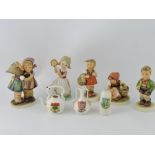 A Goebel's Hummel figurine 'Telling Her Secret', 196/0; together with three other Hummel figurines,