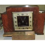 An Art Deco style oak eight day mantel clock and boxed bone dominoes.
