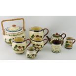 Eight pieces of Devon pottery mottoware, comprising biscuit barrel, teapot,