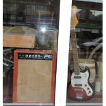 A vintage vampower valve amplifier together with an audition fender style electric guitar.