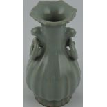 A ribbed baluster shaped vase with celadon glaze, shaped rim and two moulded ring handles, H.