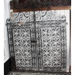 A Victorian two section wrought iron gate with scrollwork top section over quatrefoil fleur de lys