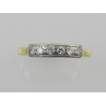 A white and yellow metal six stone diamond ring, bears indistinct marks to shank.