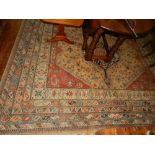 A Caucasian madder ground carpet, having three pole medallion to centre,