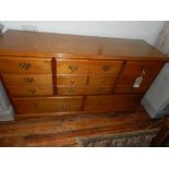 A contemporary oak sideboard, having nine drawers.