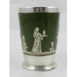 A silver mounted and pottery cup, centred with decorations of classical figures on an olive ground,