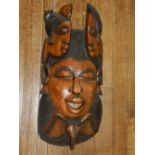 Three large African wooden wall masks, one inlaid with bone.